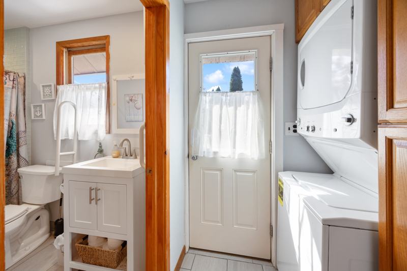 Main-level laundry with stacked washer and dryer