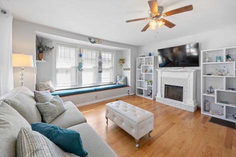 Living room with hardwood floors and a cushioned window seat